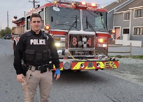 Officer standing in front of fire truck